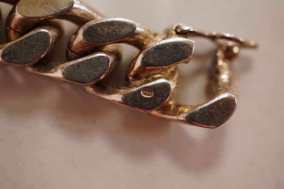 A silver necklace and bracelet, comprising: a silver ingot pendant necklace, pendant length 5.2cm including bail; and a silver curb link ID bracelet, length 20cm, each with British hallmarks, combined gross weight 82 gra